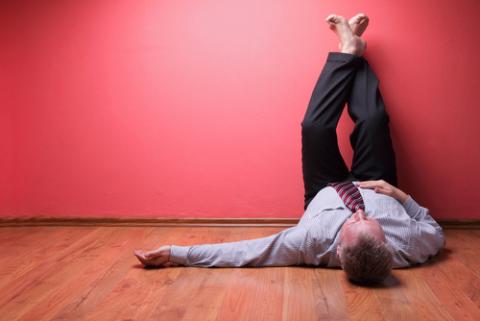 Man lying on the floor. LSaloni / Shutterstock LSaloni / Shutterstock