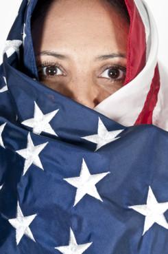 Woman wrapped in an American flag. Image courtesy Rob Byron/shutterstock.com. Woman wrapped in an American flag. Image courtesy Rob Byron/shutterstock.com.