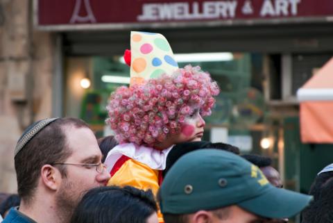 Purim carnival in Jerusalem. Unidentified people watch the show. (Ekaterina Lin / Shutterstock.com) Purim carnival in Jerusalem. Unidentified people watch the show. (Ekaterina Lin