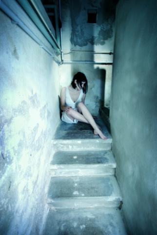 Young woman alone on stairs. Photo courtesy Kati Neudert/shutterstock.com