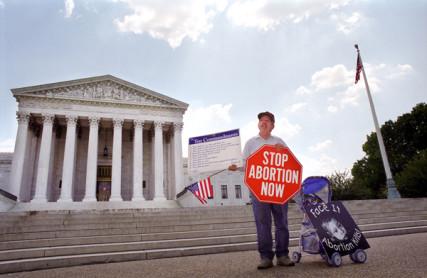 An anti-abortion protester holds a sign in front of the U.S. Supreme Court. RNS photo by Ryan Rodrick Beiler / Shutterstock.com. RNS photo by Ryan Rodrick Beiler / Shutterstock.com.