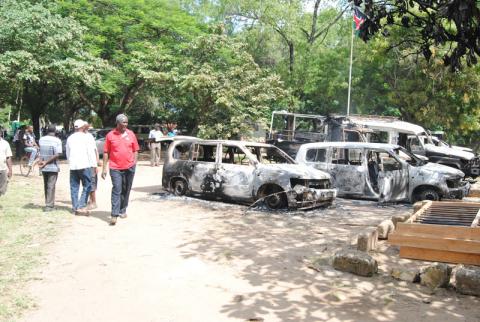 A man walks past burnt cars destroyed during a terror attack in Lamu country, June 2014. Image courtesy RNS. A man walks past burnt cars destroyed during a terror attack in Lamu country, Ju