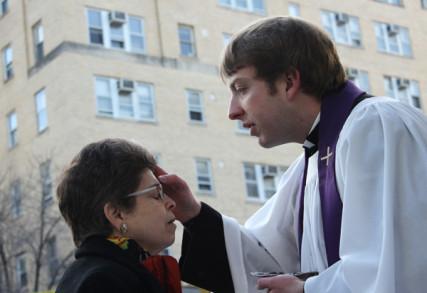 Mary Jo Binker of Rosslyn, Va., receives ashes from the Rev. Kyle Oliver on Ash Wednesday, 2014. RNS photo by Adelle M. Banks.
