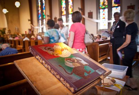 The Bible rests on a stand at the back of St. Therese Little Flower parish in Kansas City, MO. Photo courtesy RNS.