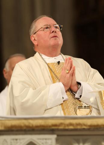 Cardinal Timothy M. Dolan prays during a Mass at St. Patrick’s Cathedral in New York. RNS photo by Gregory A. Shemitz/RNS.