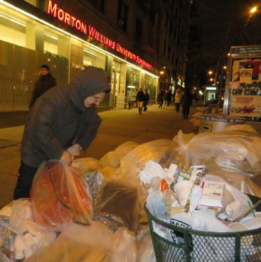 Gio Andollo looks for food in the dumpsters outside Morton WIlliams Supermarket in New York. RNS photo by Sarah Pulliam Bailey