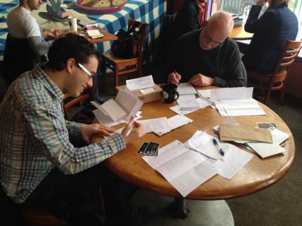 Volunteers Bill Boulden, left, and Jim Oliver, write letters to prisoners. Photo: Sarah Kaiser, Center for Inquiry Via RNS