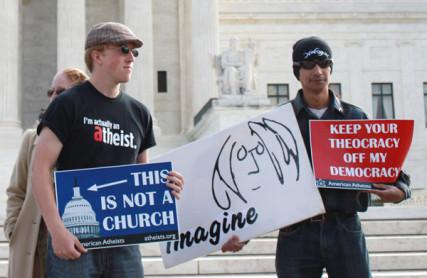 Demonstrators hold signs in front of the Supreme Court on Wednesday. RNS photo by Katherine Burgess