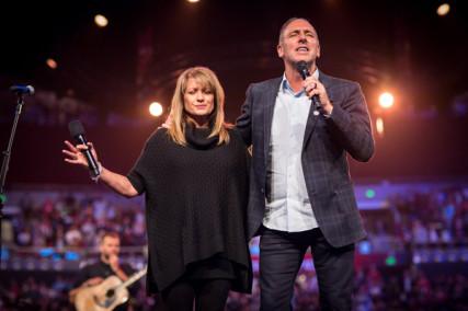 Senior Pastors Brian and Bobbie Houston in prayer at Hillsong Church. Photo via RNS/courtesy Hillsong Church