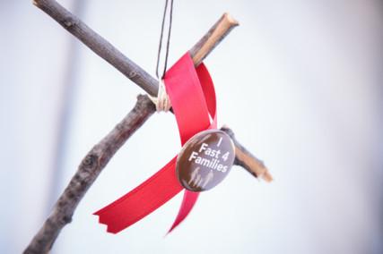 A Fast 4 Families cross, ribbon and button hang around the neck of each faster for immigration Photo courtesy Fast for Families.