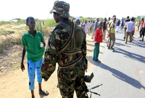 A Kenya Defense Forces soldier stops a boy from moving toward Garissa on April 2, 2015. Photo via REUTERS / Noor Khamis / RNS Photo via REUTERS / Noor Khamis / RNS