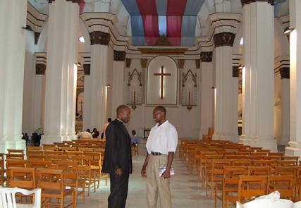 A Catholic priest converses with an Anglican pastor at Christ the King Anglican Cathedral in Tripoli. Photo: Fredrick Nzwili/RNS