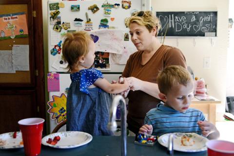 Sarah Decareaux feeds her children Elise, 2, and Finn, 4, at their home in Millstadt, Ill. Photo courtesy RNS. Photo courtesy RNS.