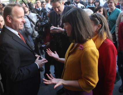 Doug Peterson refuses to let Kate Kelly (right) into the LDS General Conference. Photo: Rick Egan/The Salt Lake Tribune