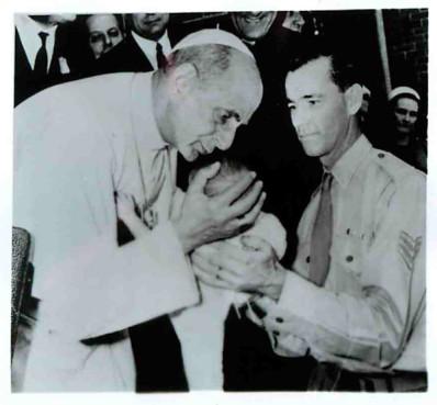 During a visit in Sydney, Pope Paul VI bends to kiss a baby. Religion News Service file photo.