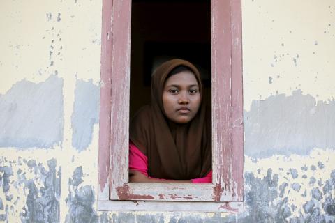 A Rohingya migrant woman inside a compound for refugees in Indonesia’s Aceh Province. Photo via REUTERS / Beawiharta / RNS Photo via REUTERS / Beawiharta / RNS