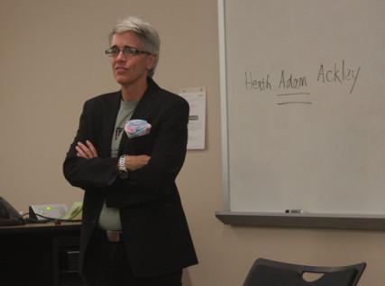 Dr. H. Adam Ackley tells his students of his transgender identity, writing his preferred name on the board. Photo by Annie Z. Yu