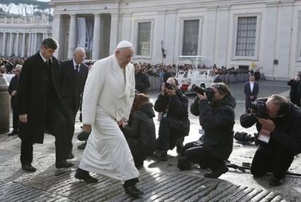 Pope Francis passes news photographers. Photo by Paul Haring, courtesy Catholic News Service. Via RNS