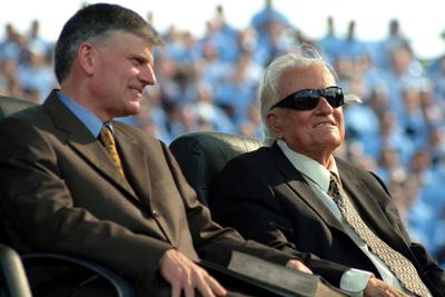 Evangelist Billy Graham, right, with son Franklin Graham, at a crusade in New York in 2005. Photo by Michael Falco.