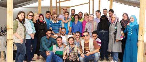 Lynne Hybels, center, with Syrian refugees and staff at the Za'atari U.N. camp. (Photo by Christine Anderson.)