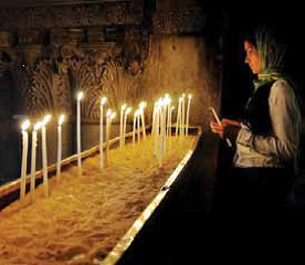 A young woman prays for peace at the Church of the Holy Sepulchre in Jerusalem. Photo by Christine M. Anderson