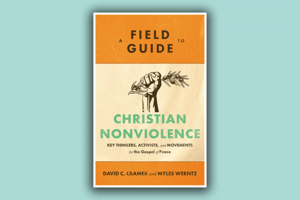 The cover of "A Field Guide to Christian Nonviolence" features a clenched hand holding an olive branch. 