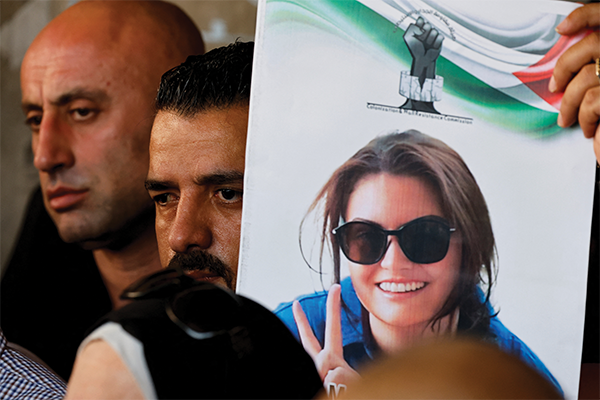 A mourner in the Israeli-occupied West Bank holds an image of Ayşenur Ezgi Eygi, a 26-year-old American volunteer with December 2024 International Solidarity Movement who was killed by Israeli forces in Nablus on Sept. 6, 2024.