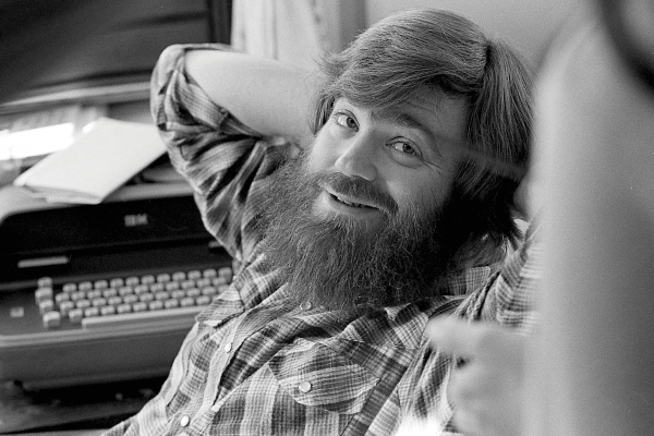 A young Jim Wallis in flannel smiling at the camera.