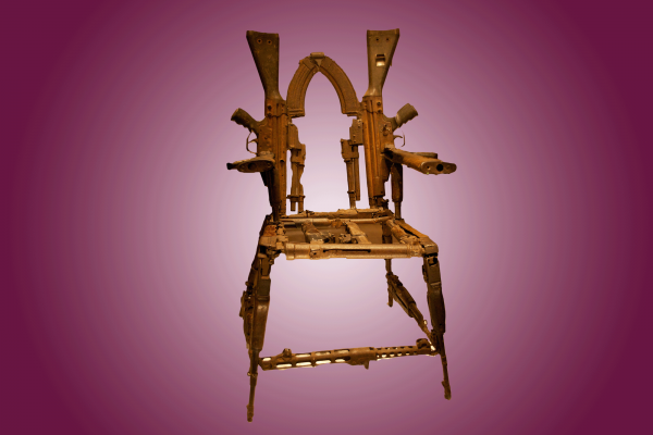 The image shows a throne made out of guns on a pink background 