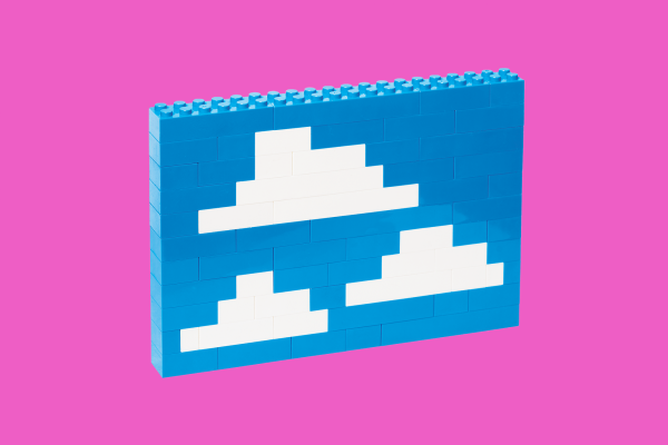 Legos built together to look like clouds in a blue sky.