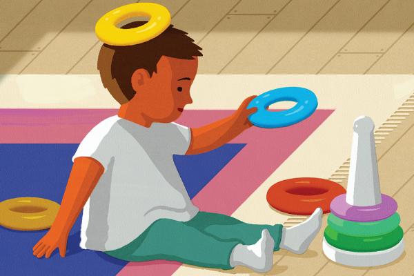 An illustration of a child with red-brown skin and dressed in white socks and a white shirt with teal pants  sitting on a rug while playing with a ring stacker toy; a yellow ring sits on its head like a halo.