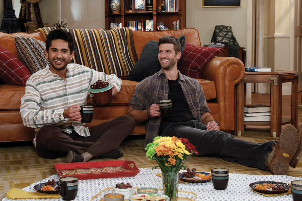 Awalmir and Riley eat a meal on the floor of the living room