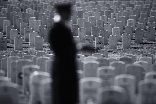 An Army honor guard holds a flag during a funeral ceremony at Arlington National Cemetery in Virginia.