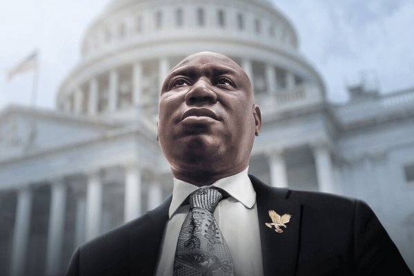 Ben Crump, dressed in a suit, looks up and away from the camera. The U.S. Capitol is in the background. 