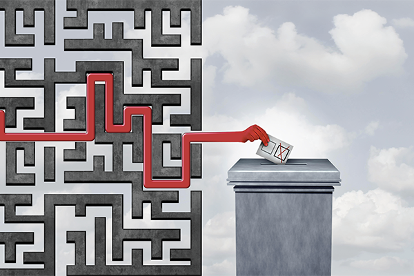 A red hand travels through a maze to deposit a vote.