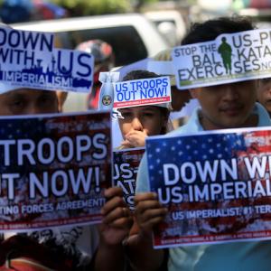 Protesters in Manila, Philippines hold signs that read "U.S. Troops Out Now" and "Down With U.S. Imperialism" outside the U.S. embassy in 2018. Romeo Ranoco / Reuters.