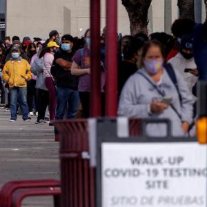 People wait outside a community center as long lines continue for individuals trying to be tested for COVID-19 during the outbreak of the coronavirus disease in San Diego, Calif., Jan. 10, 2022. 
