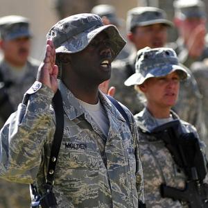 Tech. Sgt. LaMarcus Molden recites the oath of enlistment at Al Asad Air Base in