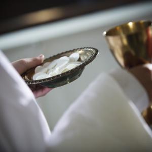 Close up of communion wafers and chalice, Ron Koeberer / Getty Images