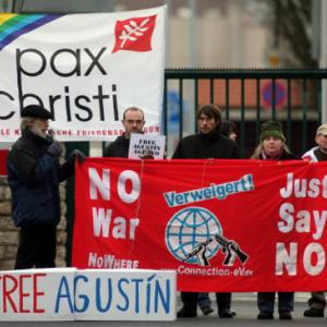 Conscientious objectors rally in Germany. Image via Getty Images.