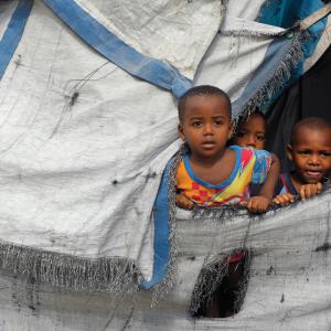 Children in a tent, Haiti 2014. Image courtesy Chuck Bigger, Compassion Internat