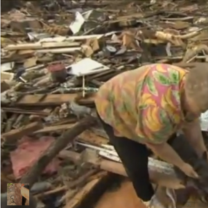 Screenshot of woman who found her dog amid tornado rubble in Moore, Okla.