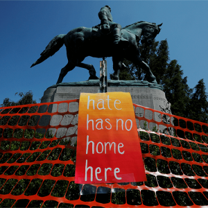 An orange sign reading "Hate Has No Home Here" hangs in front of the statue of Civil War Confederate General Robert E. Lee,
