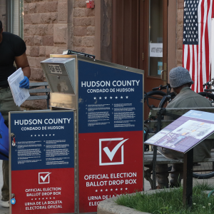 A poll worker collects mail-in ballots for the New Jersey primary election in June.