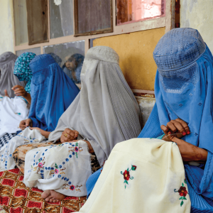 Afghan women embroider handkerchiefs at a workshop. 