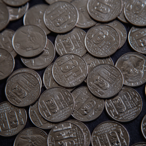 The photo shows a pile of Pauli Murray quarters 