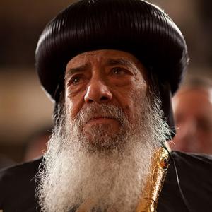 Pope Shenouda III, the Coptic Christian pontiff, listens to President Obama deli