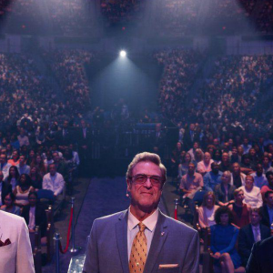 The main characters in 'The Righteous Gemstones' stand on a stage surrounded by a large crowd.