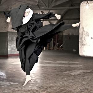 Nun kicks a heavy bag in a gym. Photo by Martin San/Getty Images. 
