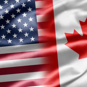 United States and Canadian flags,  ruskpp / Shutterstock.com